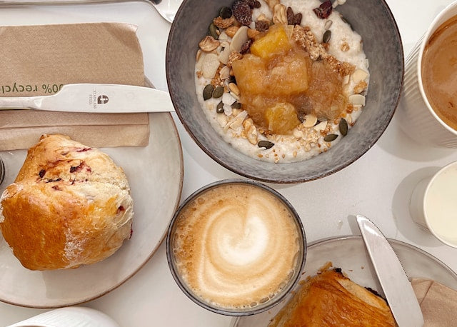 coffee with a bowl of oats and pastries